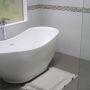 free standing bath in tiled bathroom