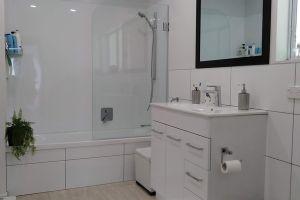 crisp white bathroom with white tiles