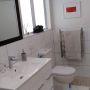 crisp white bathroom with white tiles