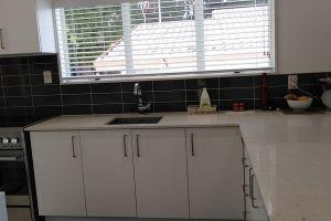 crisp white kitchen with black tiles
