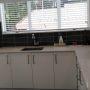 crisp white kitchen with black tiles